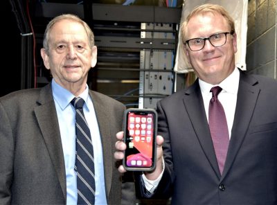 Two men holding a phone 